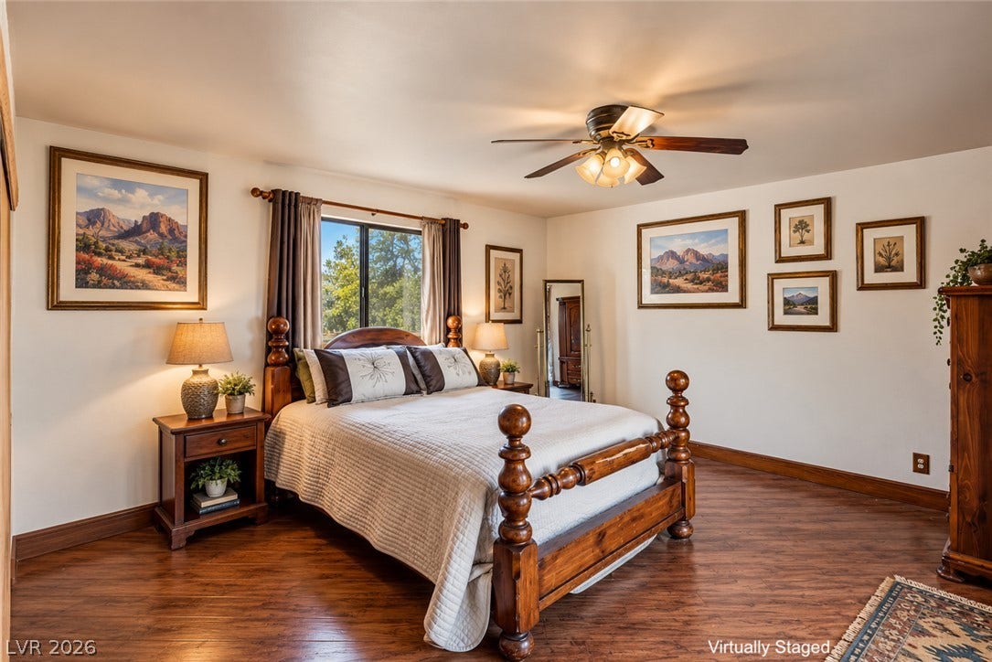 29 Cottonwood Drive, Blue Diamond, NV 89004 Rich wood flooring highlights this inviting space framing scenic outdoor views through the window.