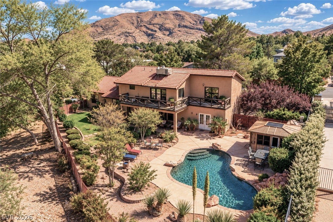 29 Cottonwood Drive, Blue Diamond, NV 89004 Mature trees and a sparkling swimming pool define this private backyard oasis with mountain backdrops.