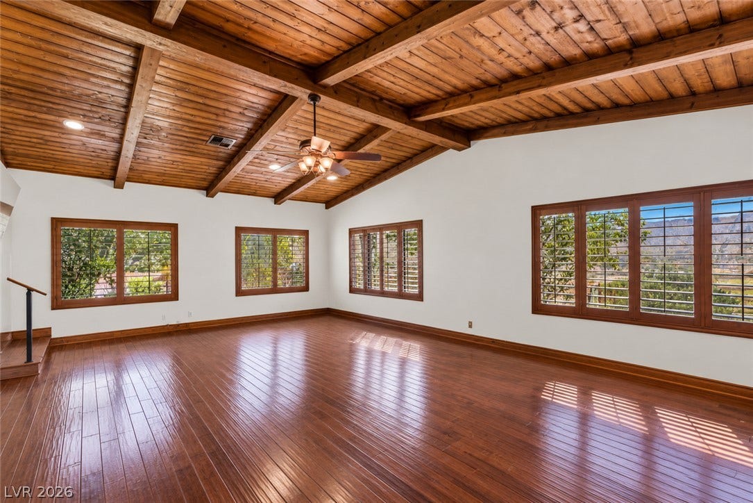 29 Cottonwood Drive, Blue Diamond, NV 89004 Rich wood plank ceilings and matching hardwood floors define this light-filled room.