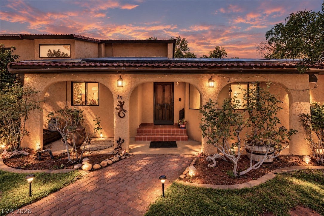 29 Cottonwood Drive, Blue Diamond, NV 89004 Arched entryways and a brick pathway welcome visitors to this beautiful stucco home.