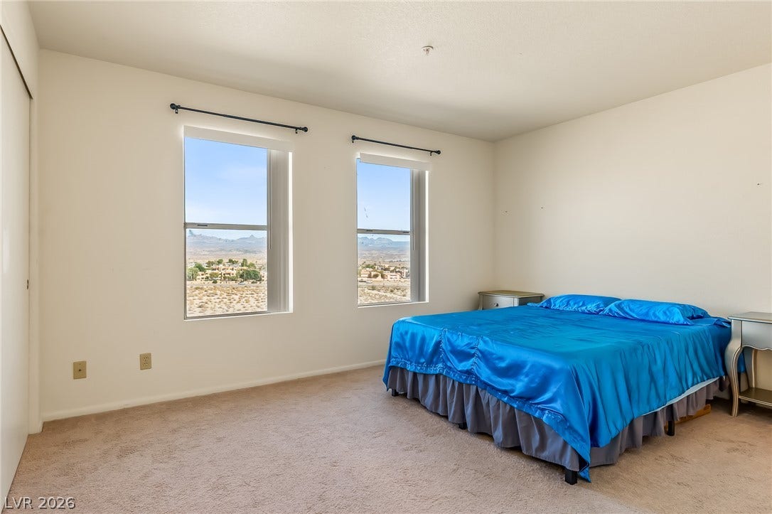 2036 Mesquite Lane, #303, Laughlin, NV 89029 Double windows frame views of the surrounding landscape in this carpeted bedroom.