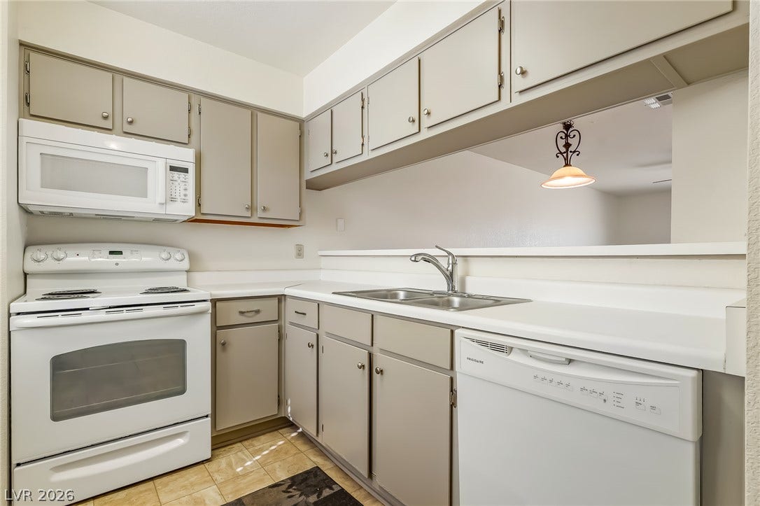 2036 Mesquite Lane, #303, Laughlin, NV 89029 Streamlined cabinetry and classic white appliances define this functional kitchen with a convenient pass-through counter.