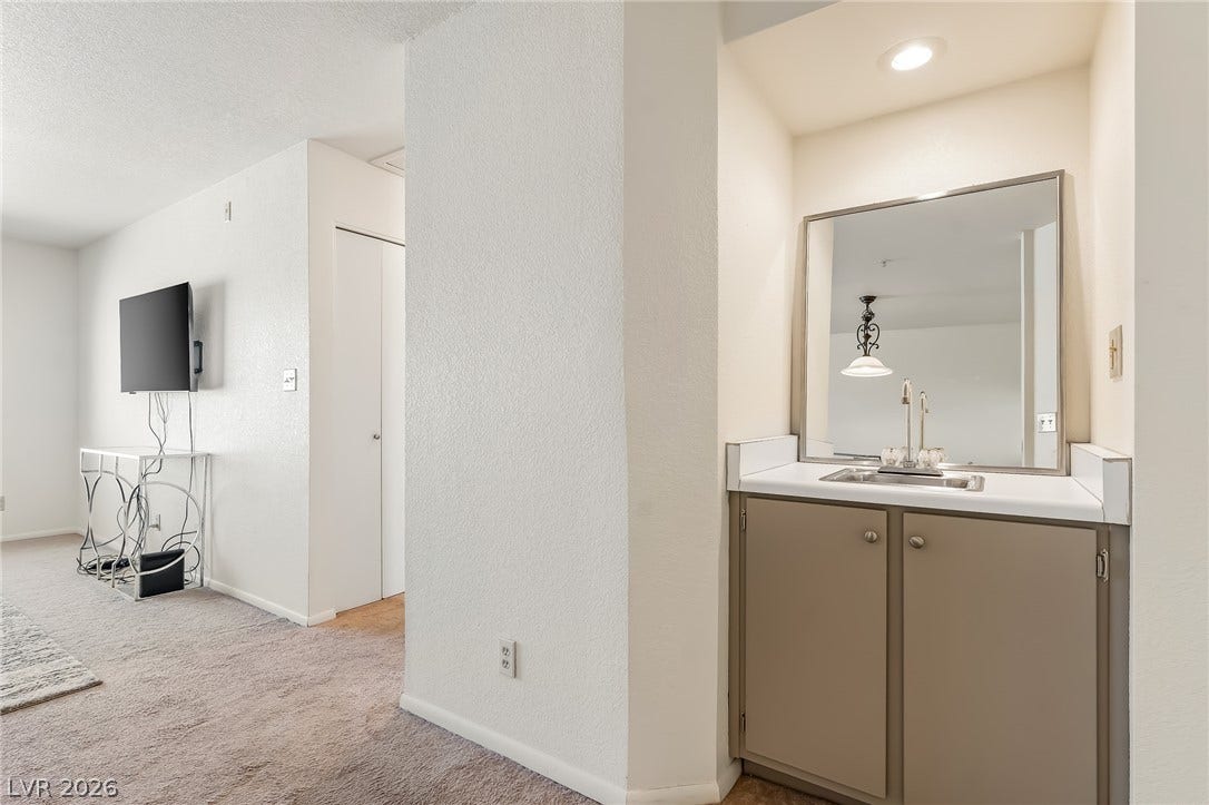 2036 Mesquite Lane, #303, Laughlin, NV 89029 A convenient wet bar alcove sits adjacent to the carpeted living space.