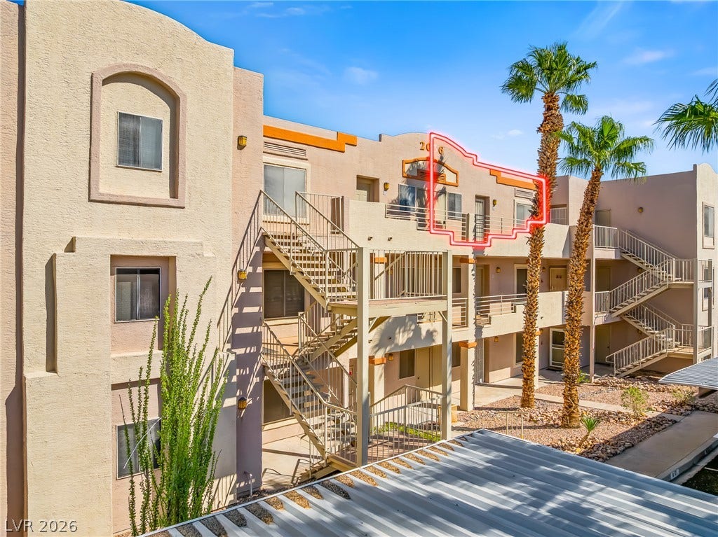 2036 Mesquite Lane, #303, Laughlin, NV 89029 Southwest-style multi-level architecture highlights this residential exterior accented by mature palm trees.