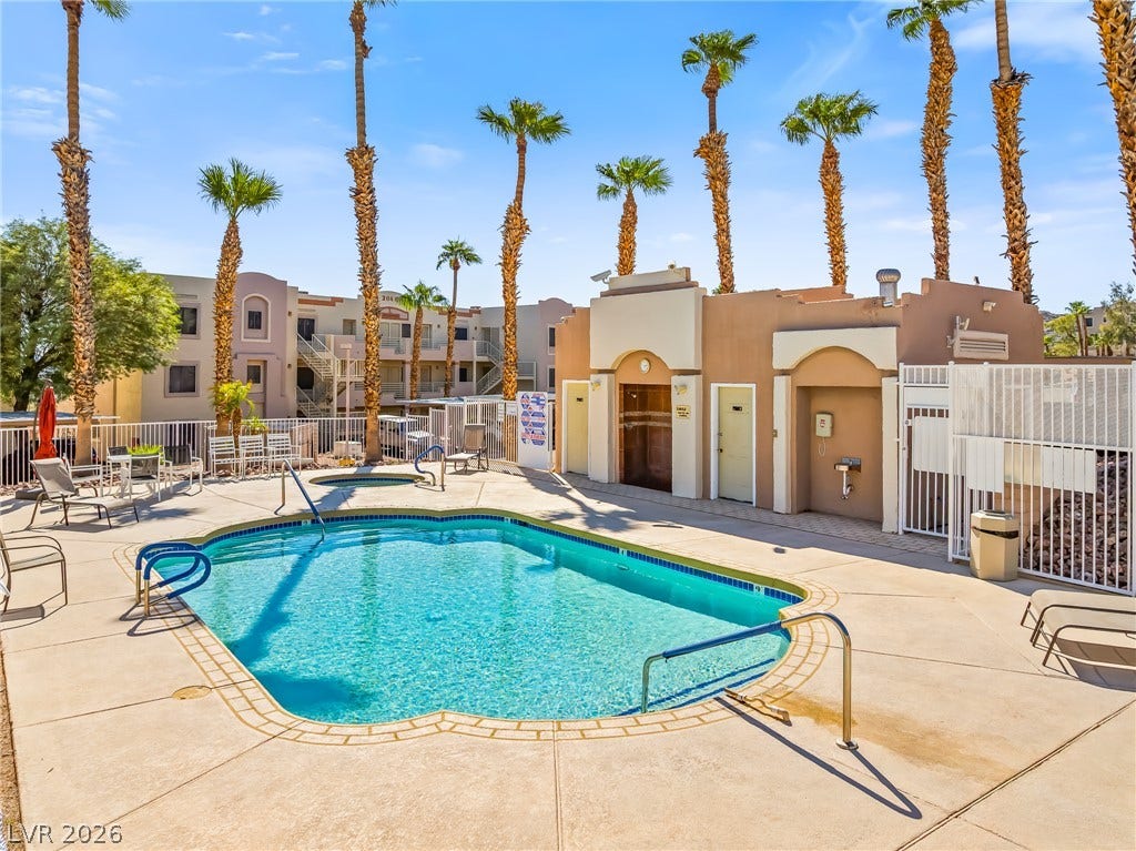 2036 Mesquite Lane, #303, Laughlin, NV 89029 Towering palm trees frame a sparkling community pool and spa area with convenient changing facilities.