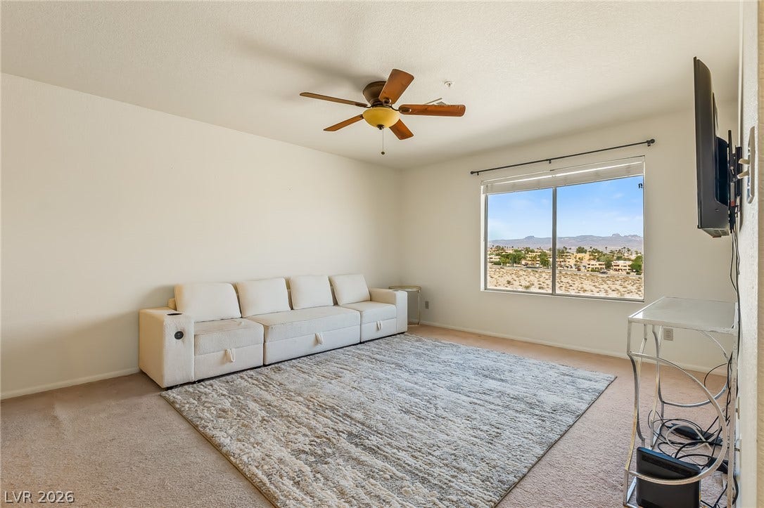 2036 Mesquite Lane, #303, Laughlin, NV 89029 A wide window framing mountain vistas anchors this comfortable carpeted living area.