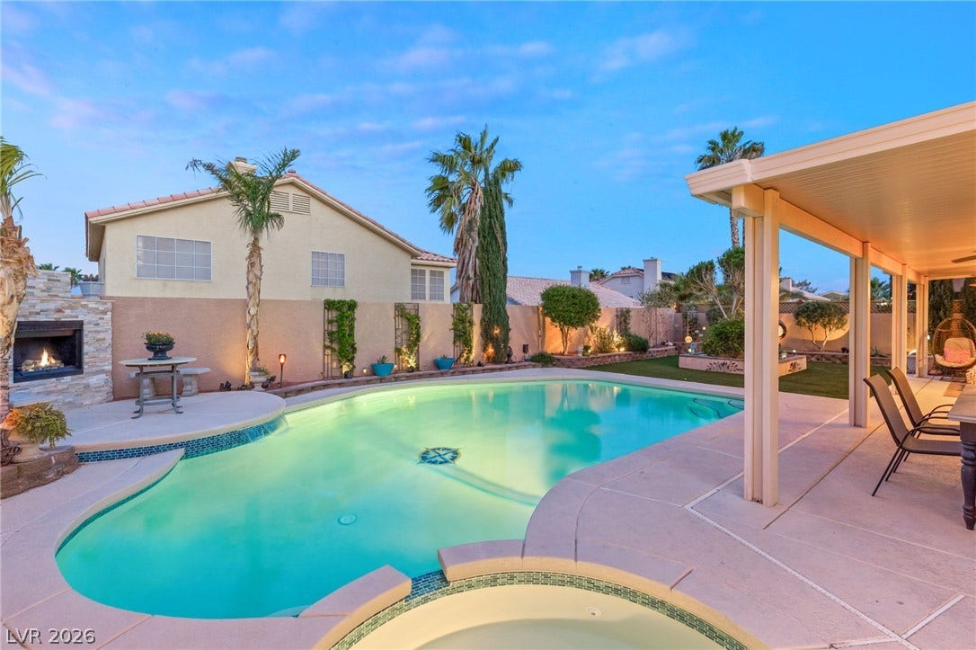 3950 Candleglow Court, Las Vegas, NV 89147 An inviting swimming pool and spa anchor this backyard oasis featuring a covered patio and outdoor fireplace.