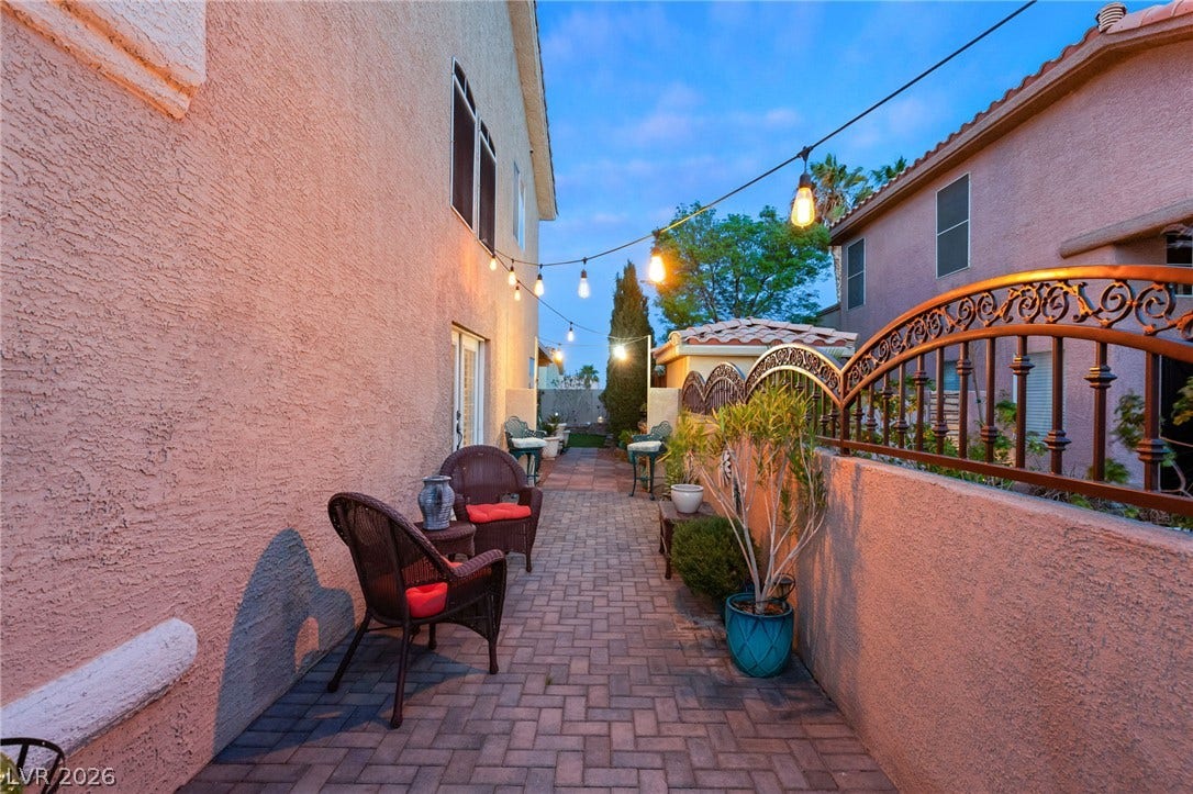 3950 Candleglow Court, Las Vegas, NV 89147 An inviting paved side courtyard features stucco walls and decorative wrought iron fencing.