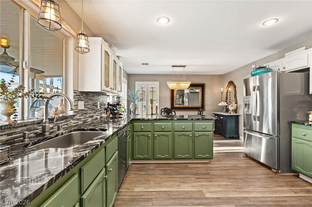3950 Candleglow Court, Las Vegas, NV 89147 Richly patterned countertops and durable wood-look flooring anchors this open cooking space.