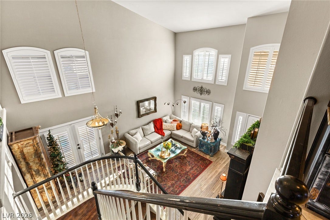 3950 Candleglow Court, Las Vegas, NV 89147 Soaring ceilings and tall arched windows define this light-filled multi-level living area.