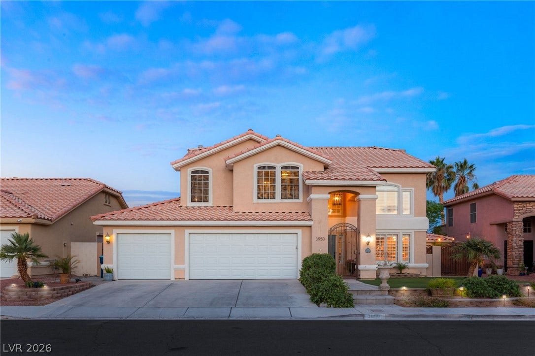 3950 Candleglow Court, Las Vegas, NV 89147 Spanish tile roofing and an arched entryway define this classic multi-level stucco exterior.