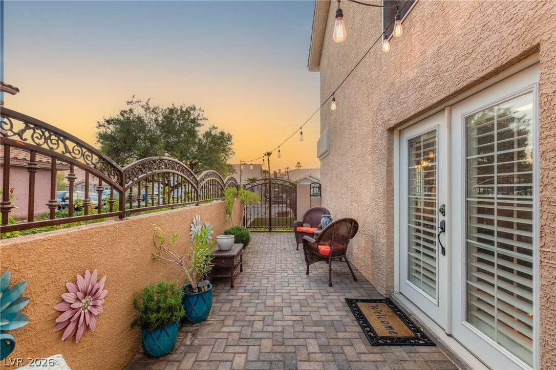 3950 Candleglow Court, Las Vegas, NV 89147 Herringbone brick pavers and a secure wrought iron fence define this private outdoor patio.