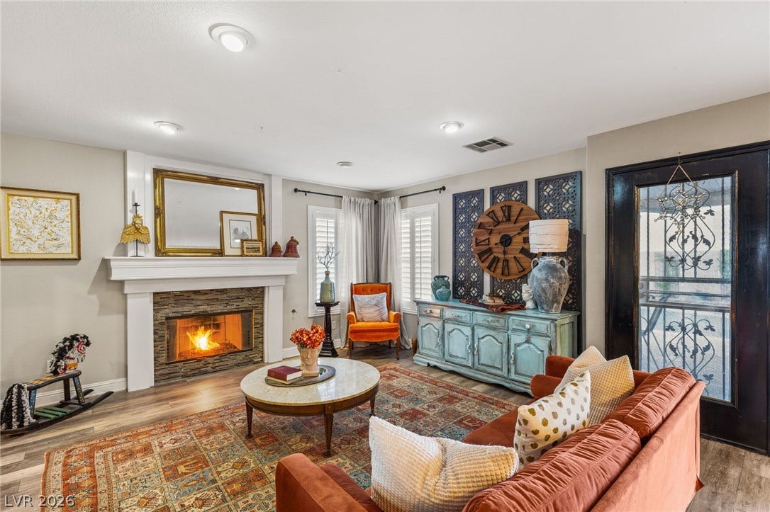 3950 Candleglow Court, Las Vegas, NV 89147 An inviting fireplace serves as the centerpiece of this comfortable living space with wood flooring.