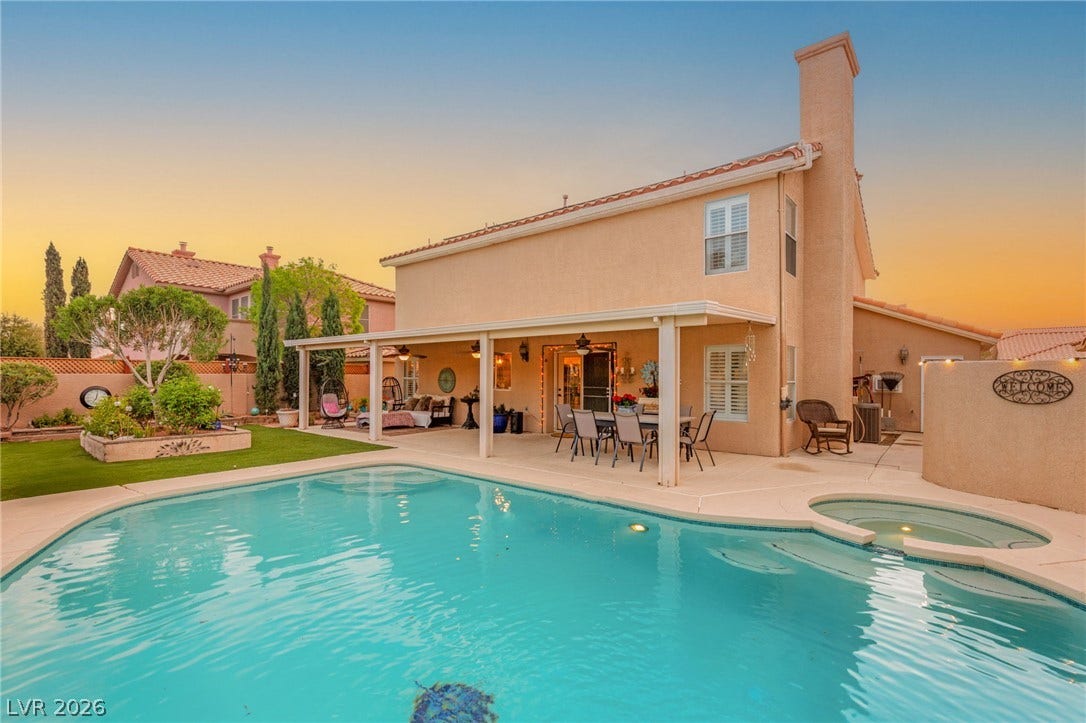 3950 Candleglow Court, Las Vegas, NV 89147 An inviting backyard oasis features a covered patio alongside a sparkling pool and spa.