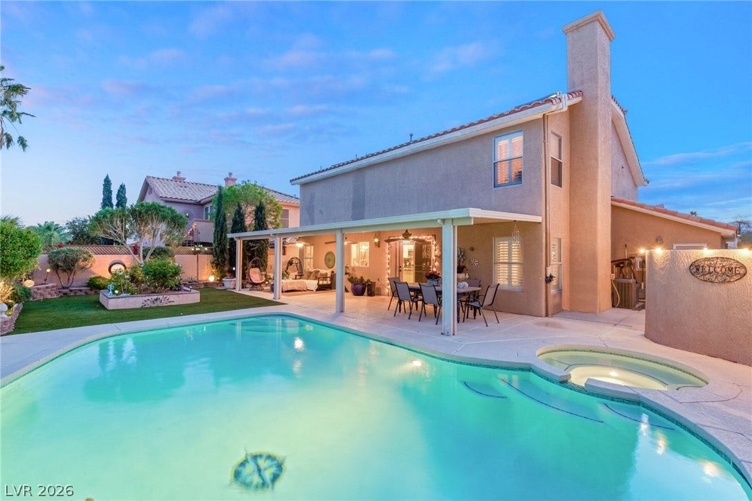 3950 Candleglow Court, Las Vegas, NV 89147 An inviting backyard oasis features a sparkling swimming pool, integrated spa, and spacious covered patio.