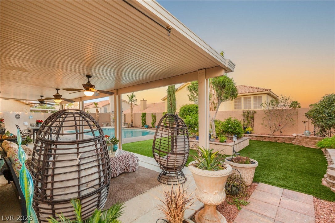 3950 Candleglow Court, Las Vegas, NV 89147 An inviting covered patio opens up to a manicured yard and a sparkling swimming pool.