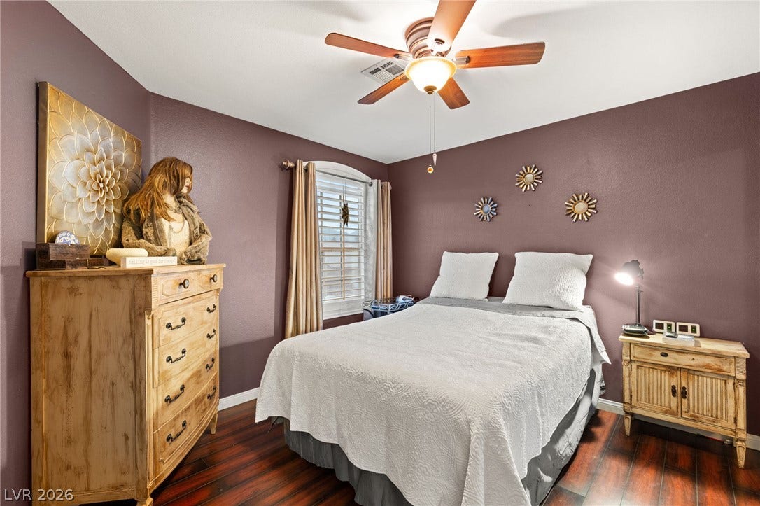 3950 Candleglow Court, Las Vegas, NV 89147 Gleaming hardwood floors and a classic arched window define this cozy bedroom retreat.