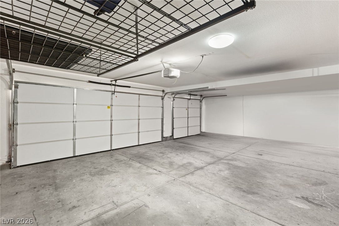 3950 Candleglow Court, Las Vegas, NV 89147 An accommodating multi-car garage provides extensive concrete flooring and overhead storage racks.