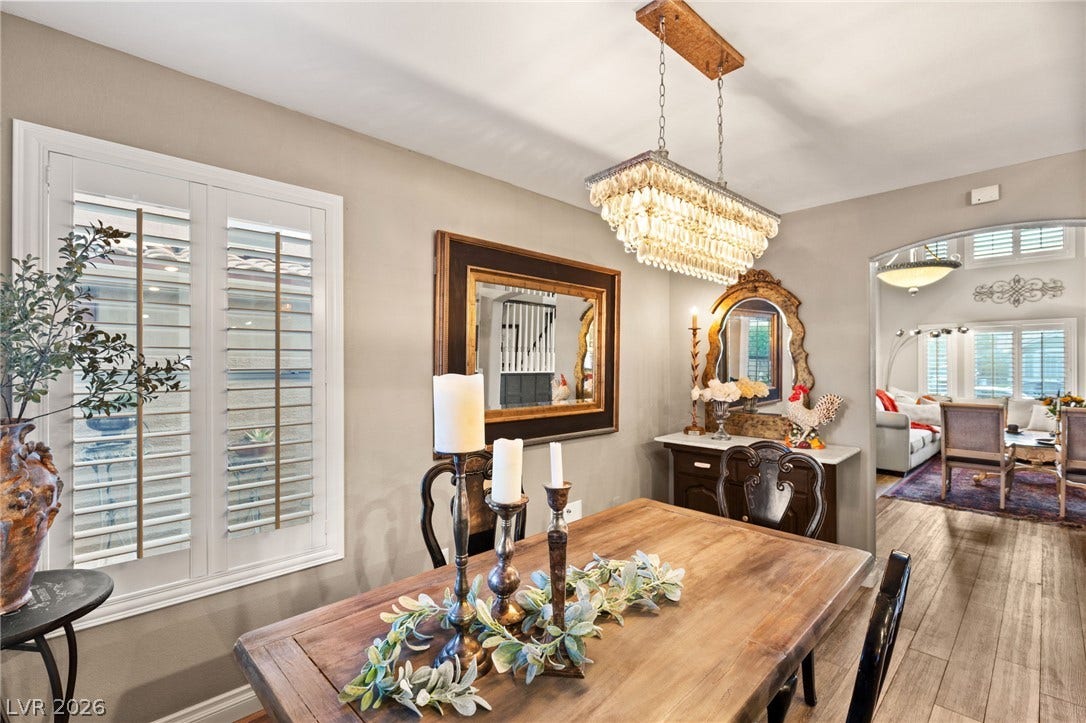 3950 Candleglow Court, Las Vegas, NV 89147 An elegant dining space features a magnificent crystal chandelier suspended over hardwood floors.