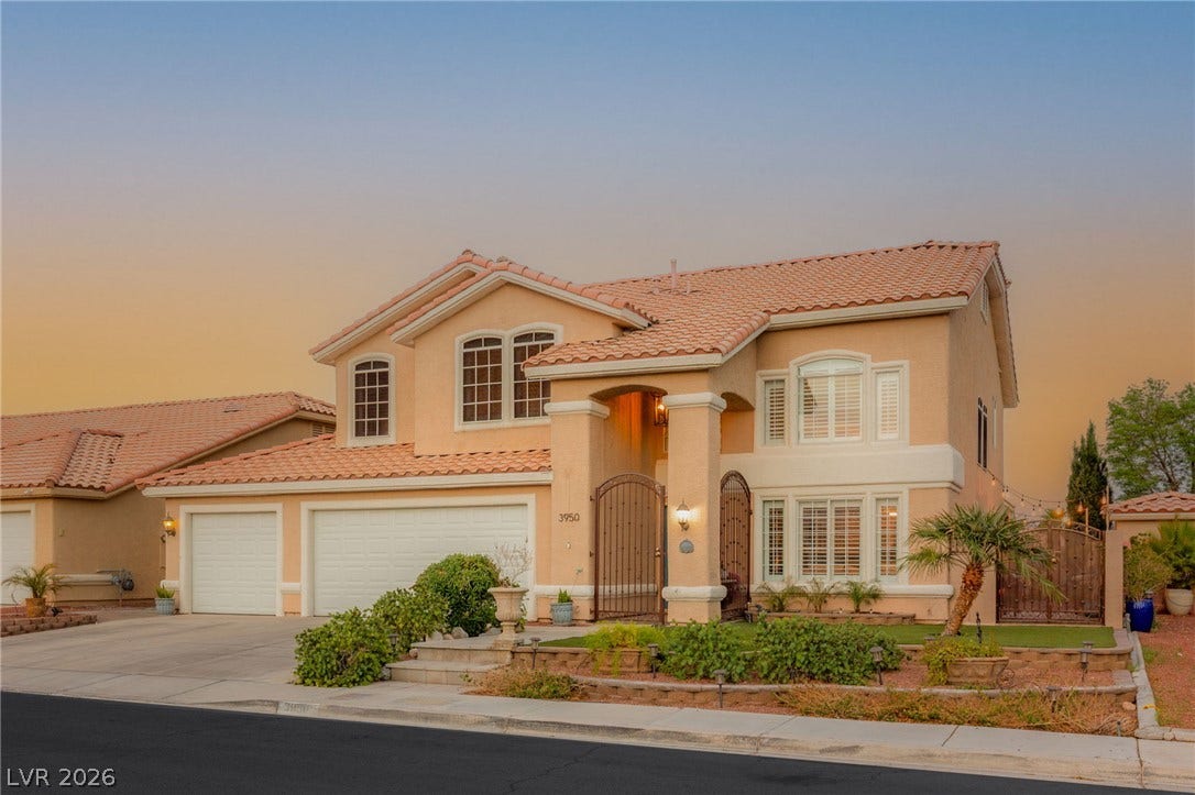 3950 Candleglow Court, Las Vegas, NV 89147 Elegant Mediterranean architecture defines this double-story residence complete with a tile roof and gated entry.