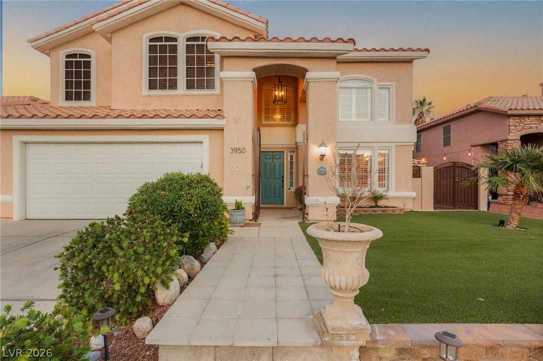 3950 Candleglow Court, Las Vegas, NV 89147 A paved walkway leads past a manicured lawn to the welcoming entrance of this residence.