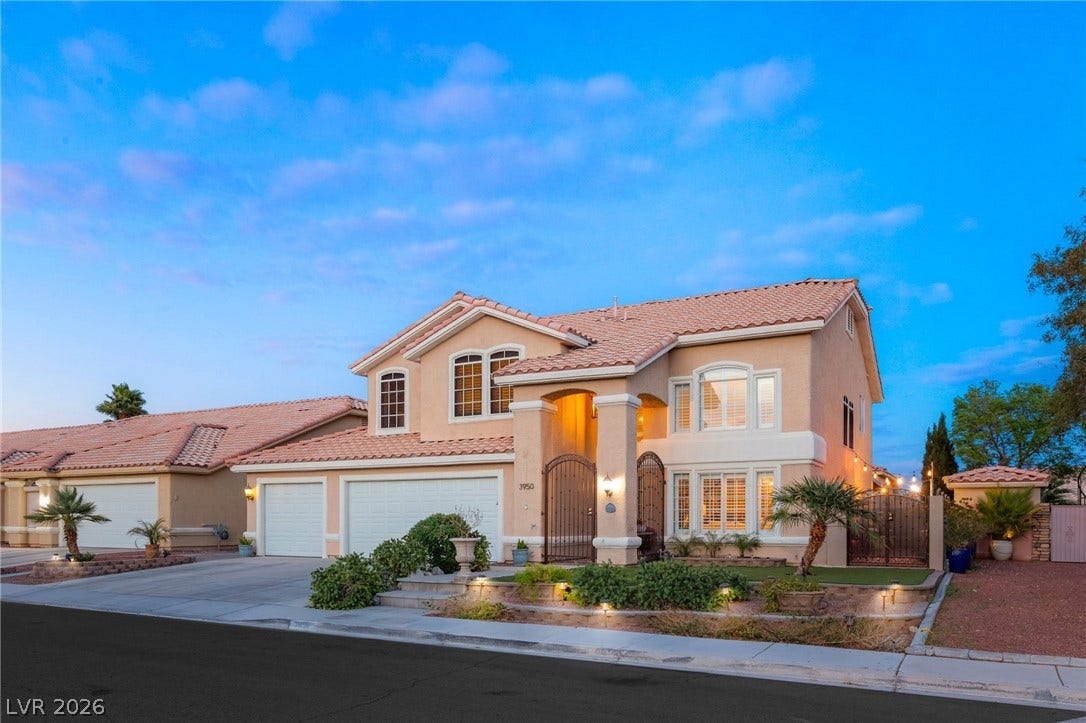 3950 Candleglow Court, Las Vegas, NV 89147 Spanish tile roofing and custom arched windows elevate this classic multi-level design.