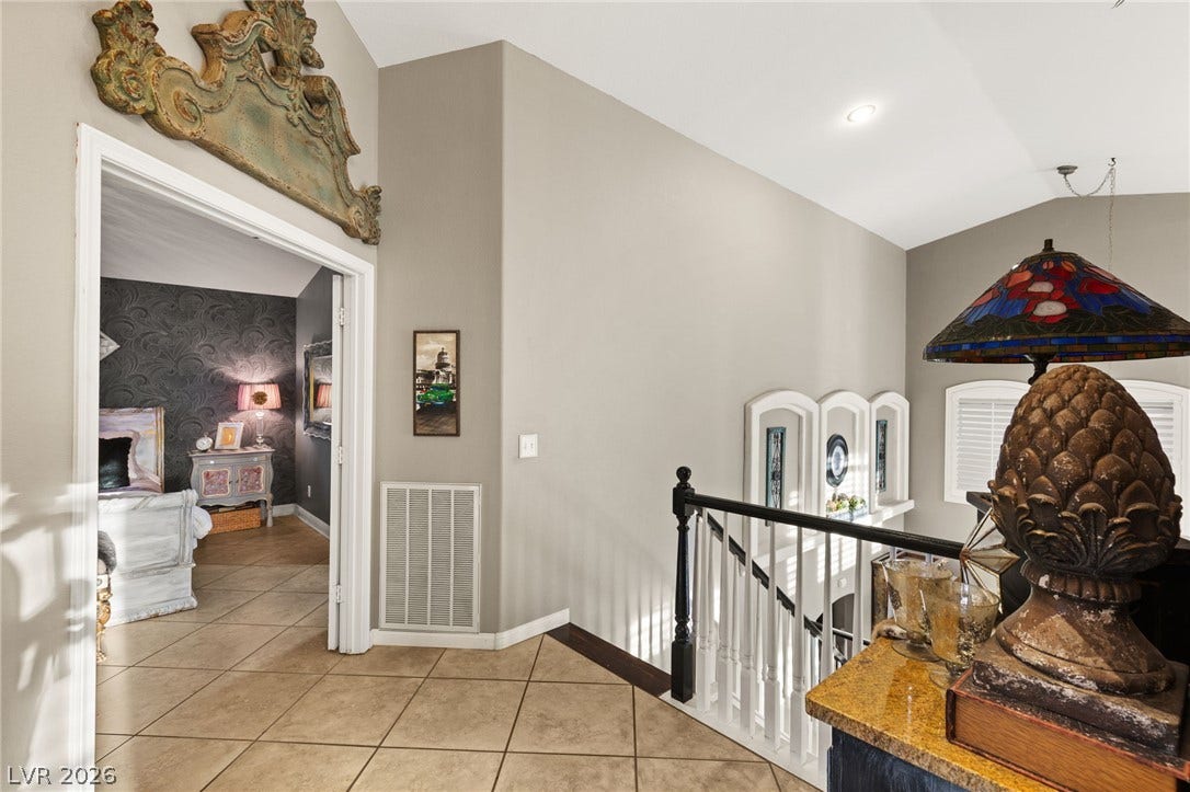3950 Candleglow Court, Las Vegas, NV 89147 High ceilings and neutral tile flooring define this upper-level landing overlooking the stairs.