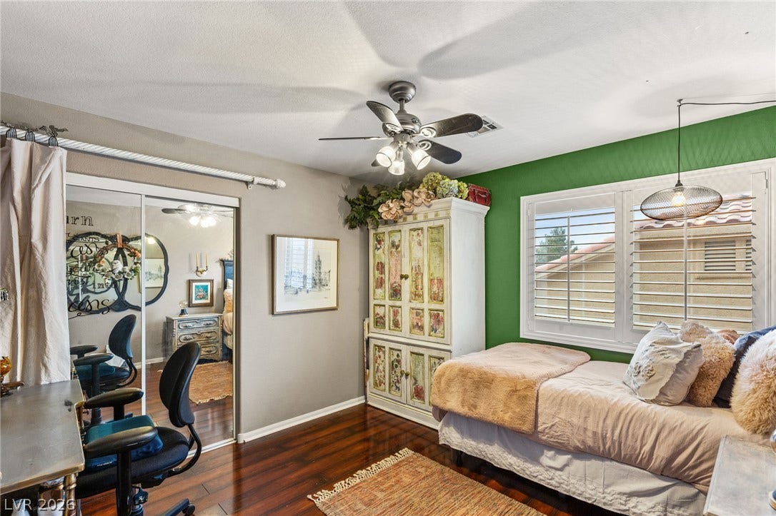 3950 Candleglow Court, Las Vegas, NV 89147 Rich hardwood flooring anchors this light-filled room complete with sliding mirrored closets.