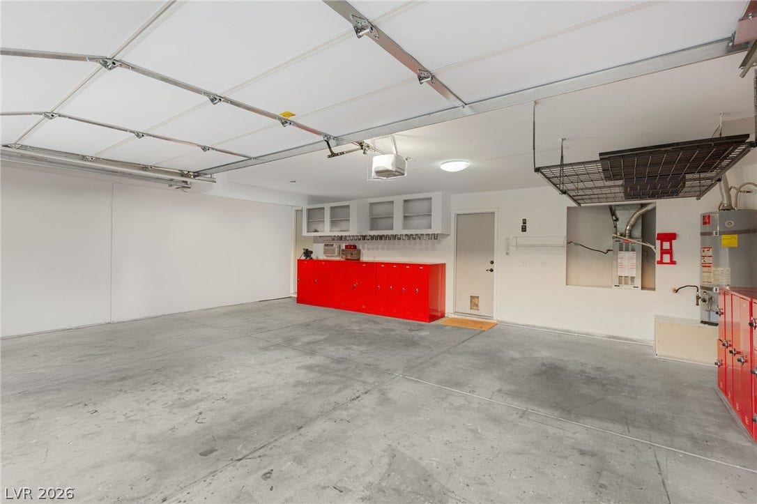 3950 Candleglow Court, Las Vegas, NV 89147 An expansive garage space features a durable concrete floor and functional built-in storage solutions.
