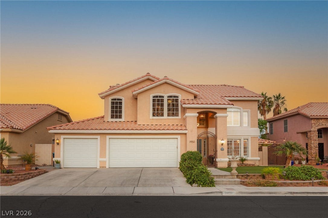 3950 Candleglow Court, Las Vegas, NV 89147 An inviting exterior displays multi-paned windows, a tiled roofline, and attached multi-car garage space.