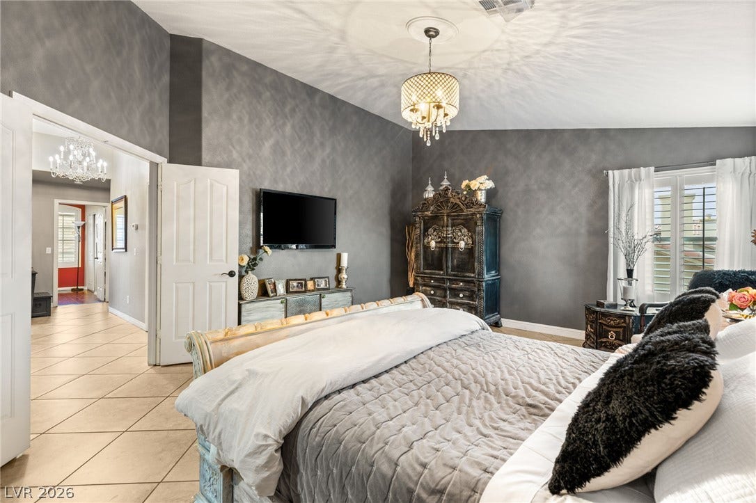 3950 Candleglow Court, Las Vegas, NV 89147 High vaulted ceilings and textured walls create an airy ambiance in this peaceful bedroom.