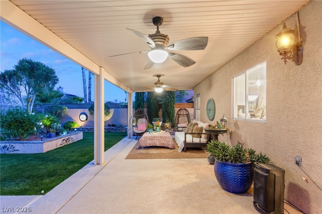 3950 Candleglow Court, Las Vegas, NV 89147 A sheltered concrete patio opens directly onto a manicured green lawn.