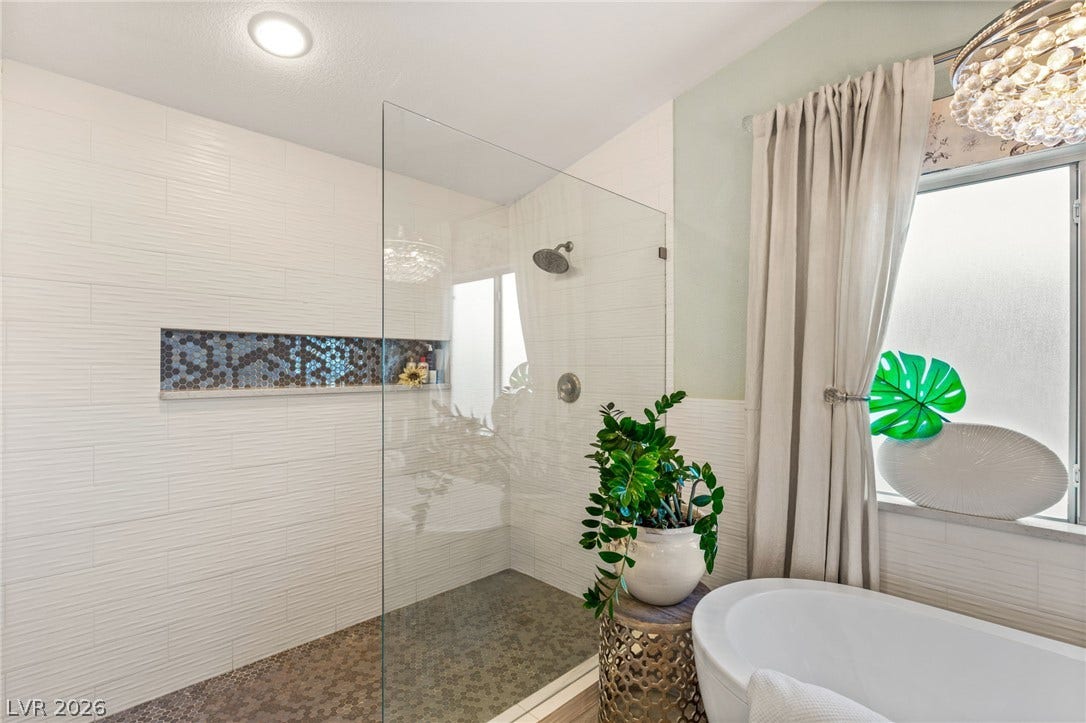 3950 Candleglow Court, Las Vegas, NV 89147 Elegant tiled walk-in shower and freestanding soaking tub offer a spa-like retreat.