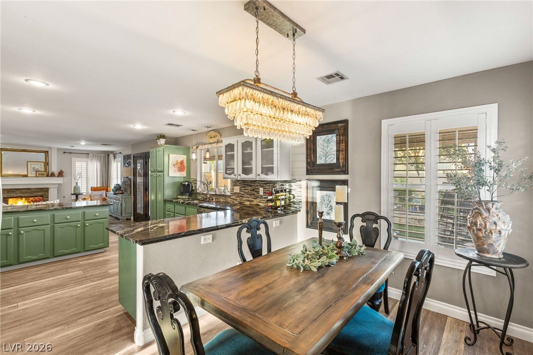 3950 Candleglow Court, Las Vegas, NV 89147 An open dining area flows seamlessly into the kitchen over warm wood-look flooring.