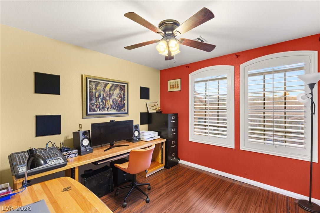 3950 Candleglow Court, Las Vegas, NV 89147 Rich wood flooring anchors this versatile space illuminated by arched windows.