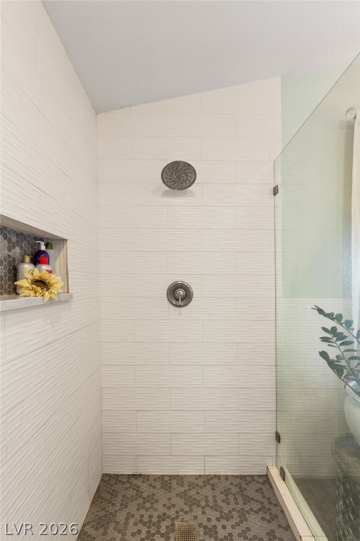 3950 Candleglow Court, Las Vegas, NV 89147 Modern tile work and a glass enclosure define this contemporary walk-in shower.