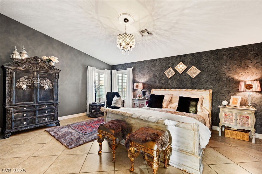 3950 Candleglow Court, Las Vegas, NV 89147 Textured walls and tiled flooring define this spacious bedroom under a high vaulted ceiling.