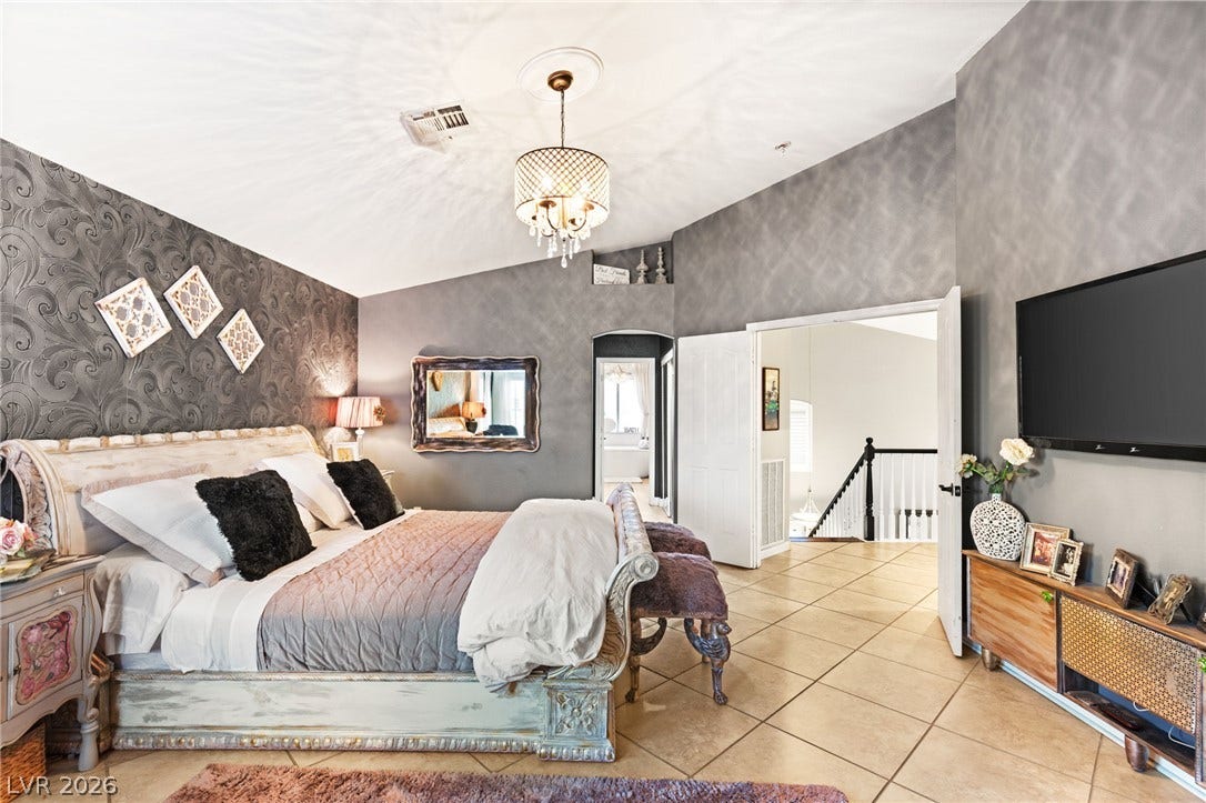 3950 Candleglow Court, Las Vegas, NV 89147 High vaulted ceilings and tile flooring enhance this spacious bedroom suite.