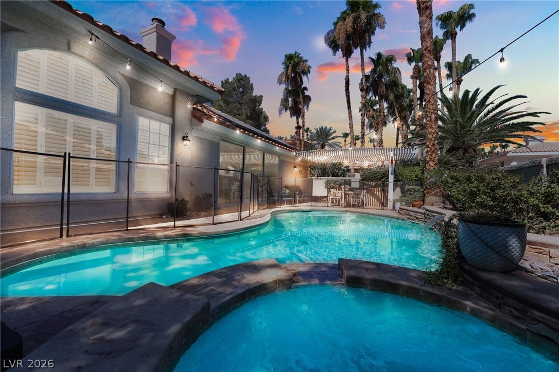 1892 Woodhaven Drive, Henderson, NV 89074 An inviting backyard oasis awaits with a sparkling pool and spa, perfect for twilight entertaining. Removable safety fence.