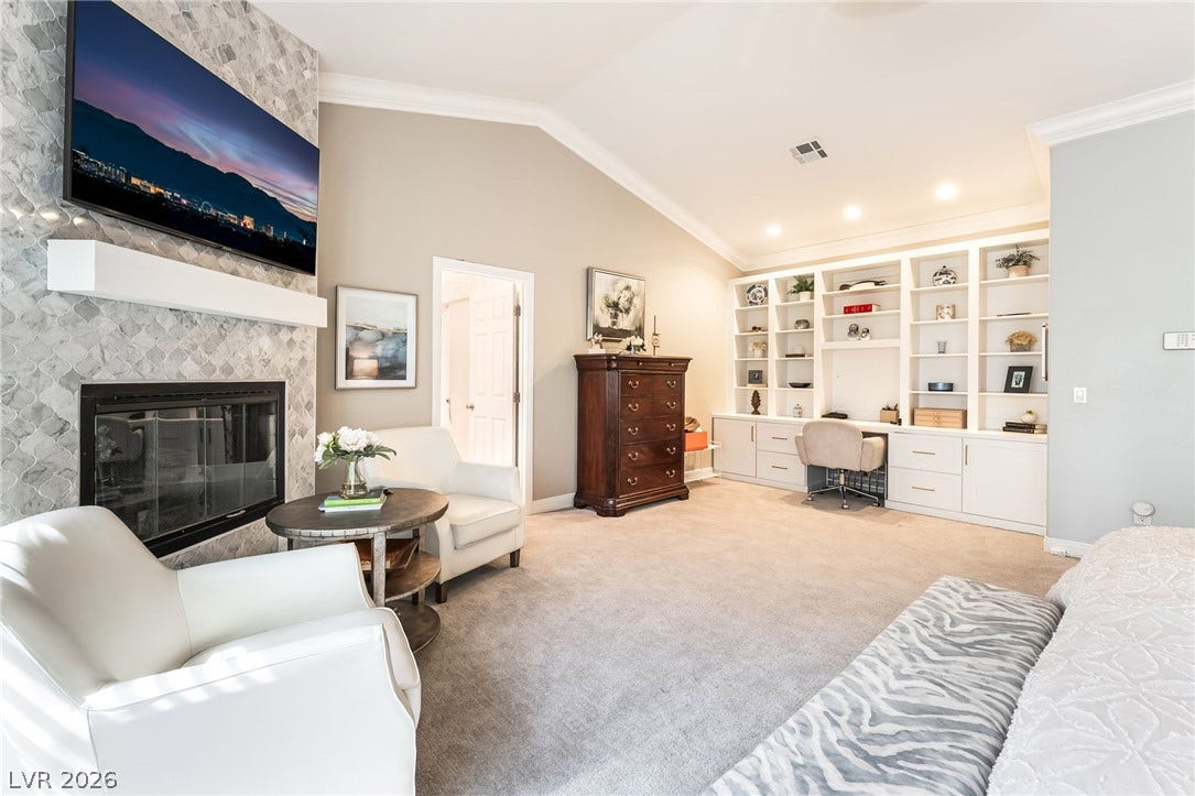 1892 Woodhaven Drive, Henderson, NV 89074 Custom built-in shelving offers ample storage and a dedicated workspace within this elegant room.