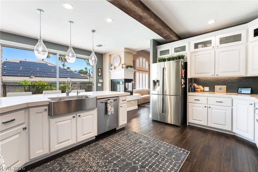 1892 Woodhaven Drive, Henderson, NV 89074 A well-appointed kitchen showcasing a spacious island with a farm sink and views of the outdoor living space.