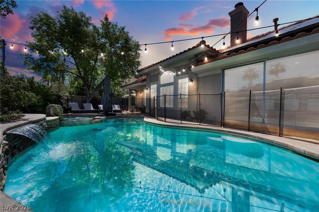 1892 Woodhaven Drive, Henderson, NV 89074 An inviting pool area with a waterfall feature, perfect for evening relaxation.