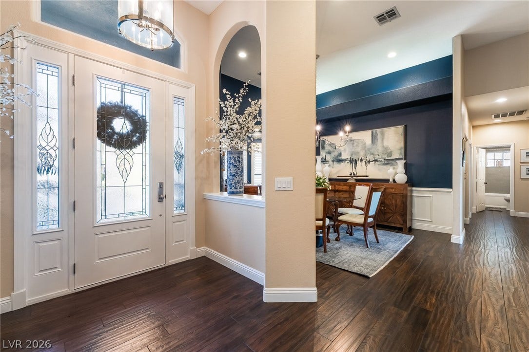 1892 Woodhaven Drive, Henderson, NV 89074 Ornate leaded glass sidelights and transom frame the entryway, welcoming guests into this residence.