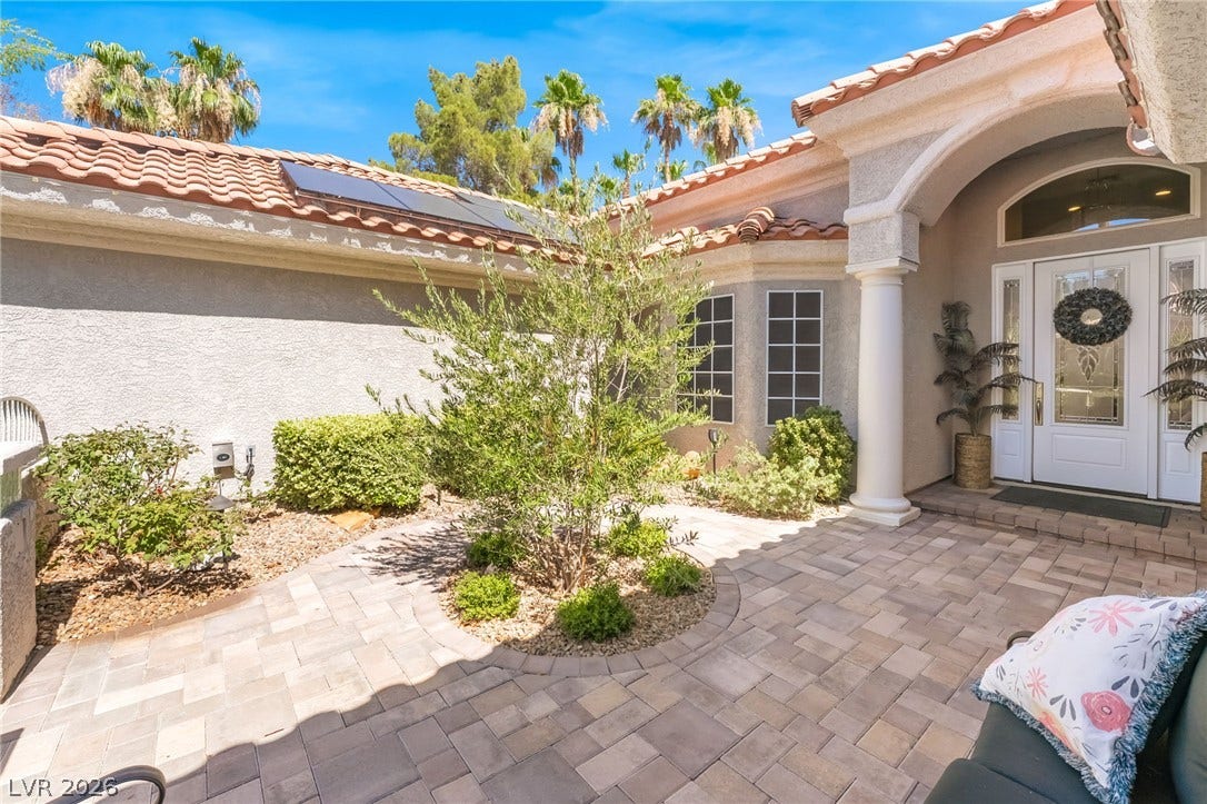 1892 Woodhaven Drive, Henderson, NV 89074 A terracotta-tiled roof and solar panels enhance the energy efficiency and aesthetic of this home's entrance.