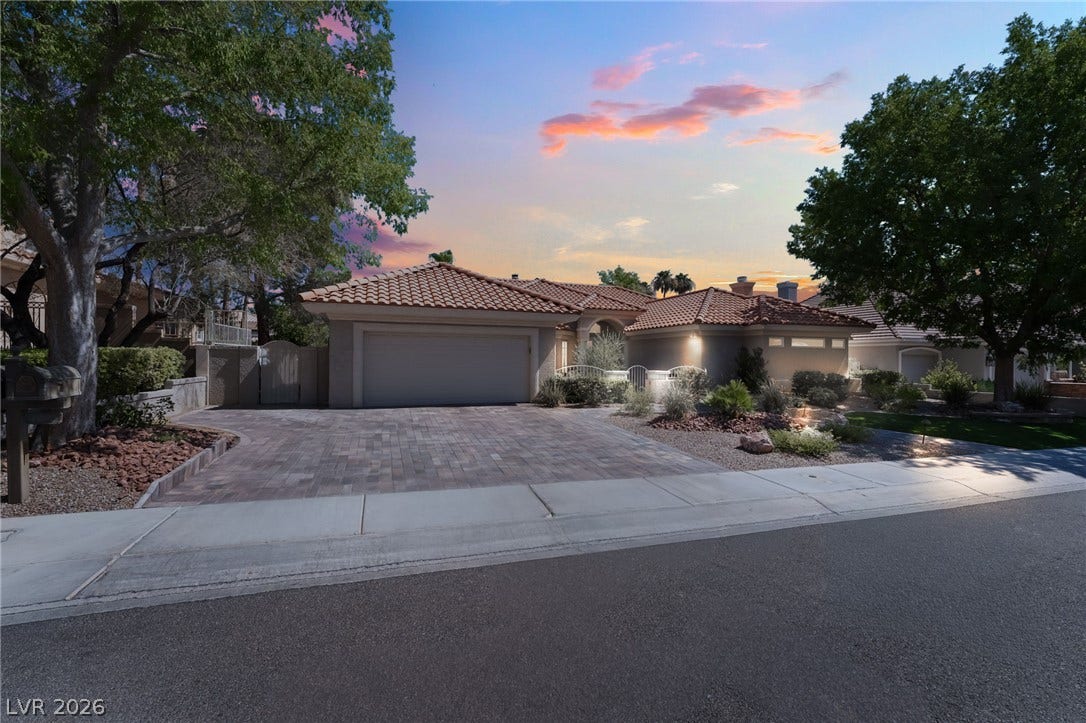 1892 Woodhaven Drive, Henderson, NV 89074 Spanish-style facade with a tiled roof and ample driveway welcomes you home.