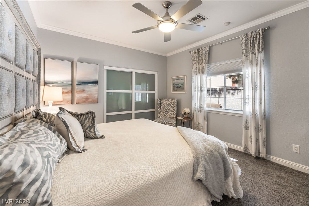 1892 Woodhaven Drive, Henderson, NV 89074 A tranquil bedroom retreat features a ceiling fan, crown molding, and plush carpeting.