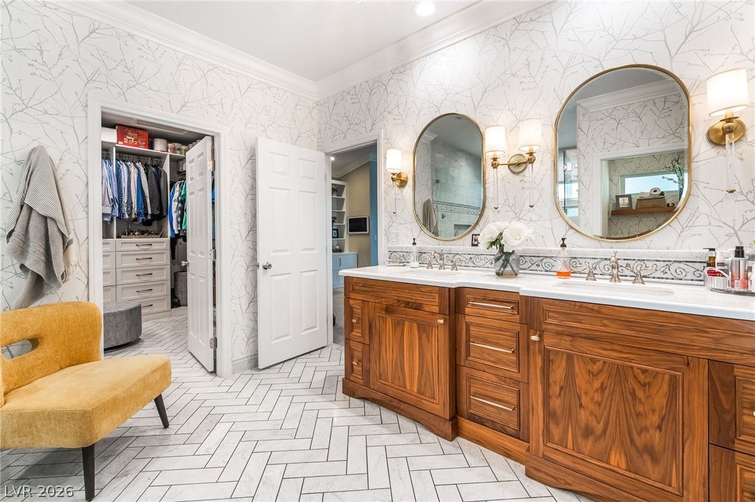 1892 Woodhaven Drive, Henderson, NV 89074 Luxurious double vanity with custom cabinetry and elegant mirrors graces this sophisticated bath space.