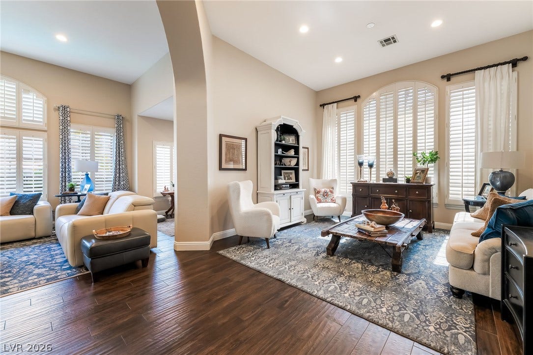 1892 Woodhaven Drive, Henderson, NV 89074 Hardwood floors and tall arched windows define this elegant, sun-filled living space.