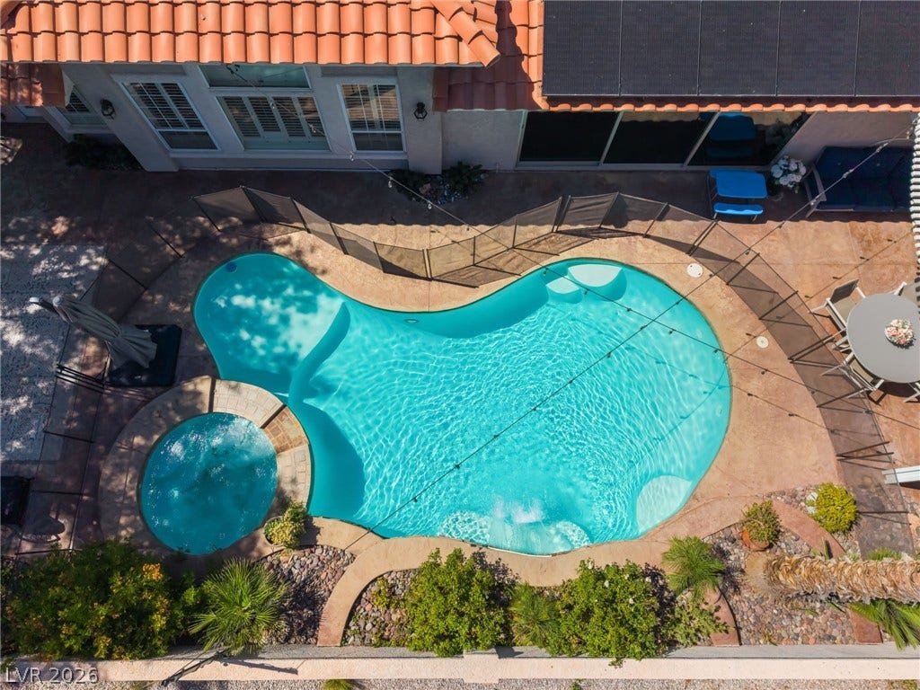 1892 Woodhaven Drive, Henderson, NV 89074 An inviting backyard oasis awaits with a sparkling pool and integrated spa.