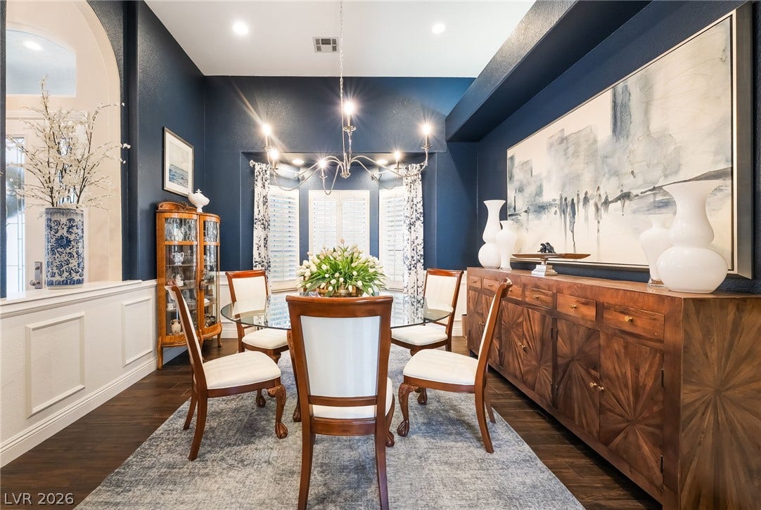 1892 Woodhaven Drive, Henderson, NV 89074 A sophisticated dining area showcasing wood flooring and an elegant chandelier.